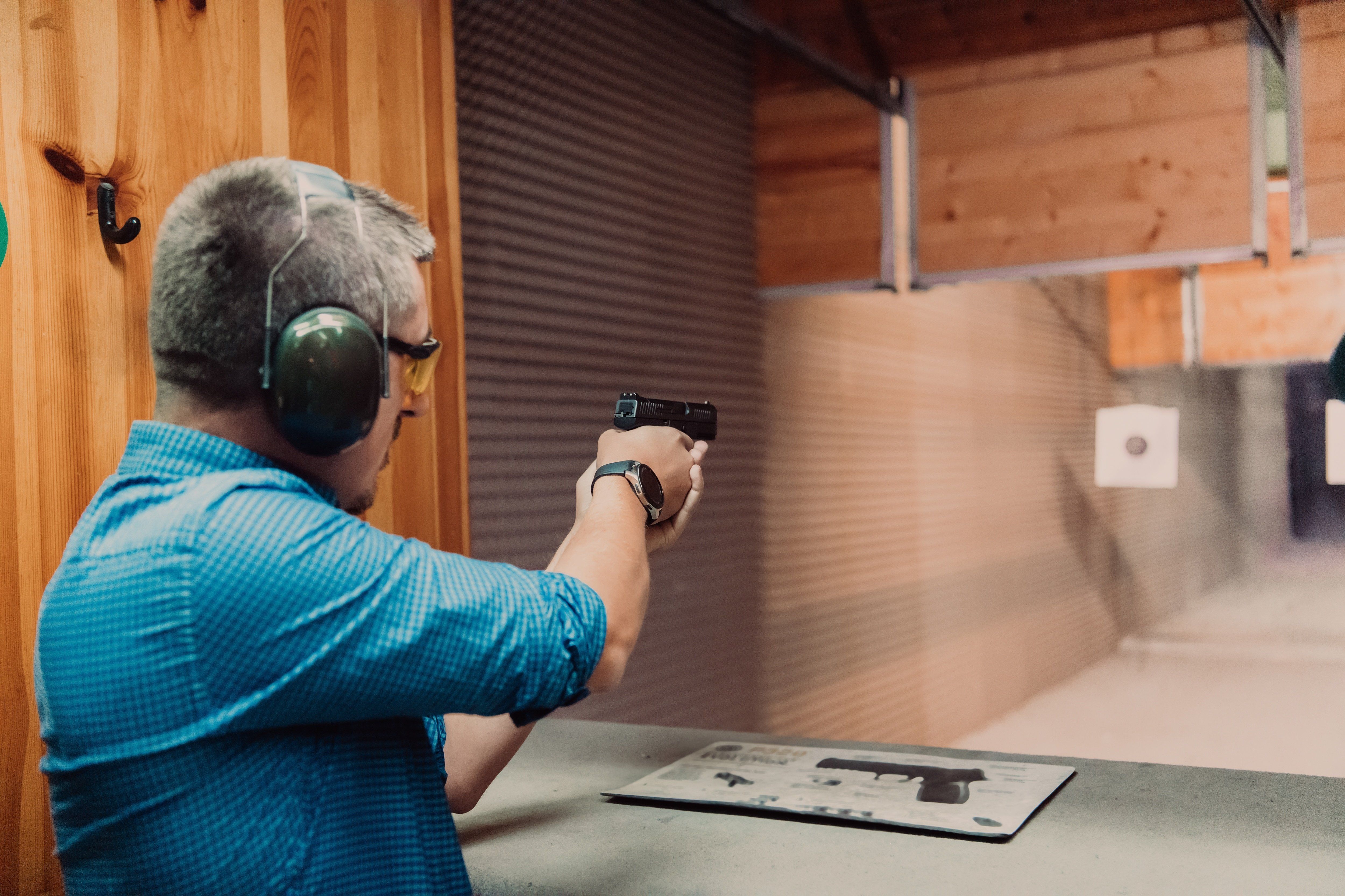 A,Man,Practices,Shooting,A,Pistol,In,A,Shooting,Range