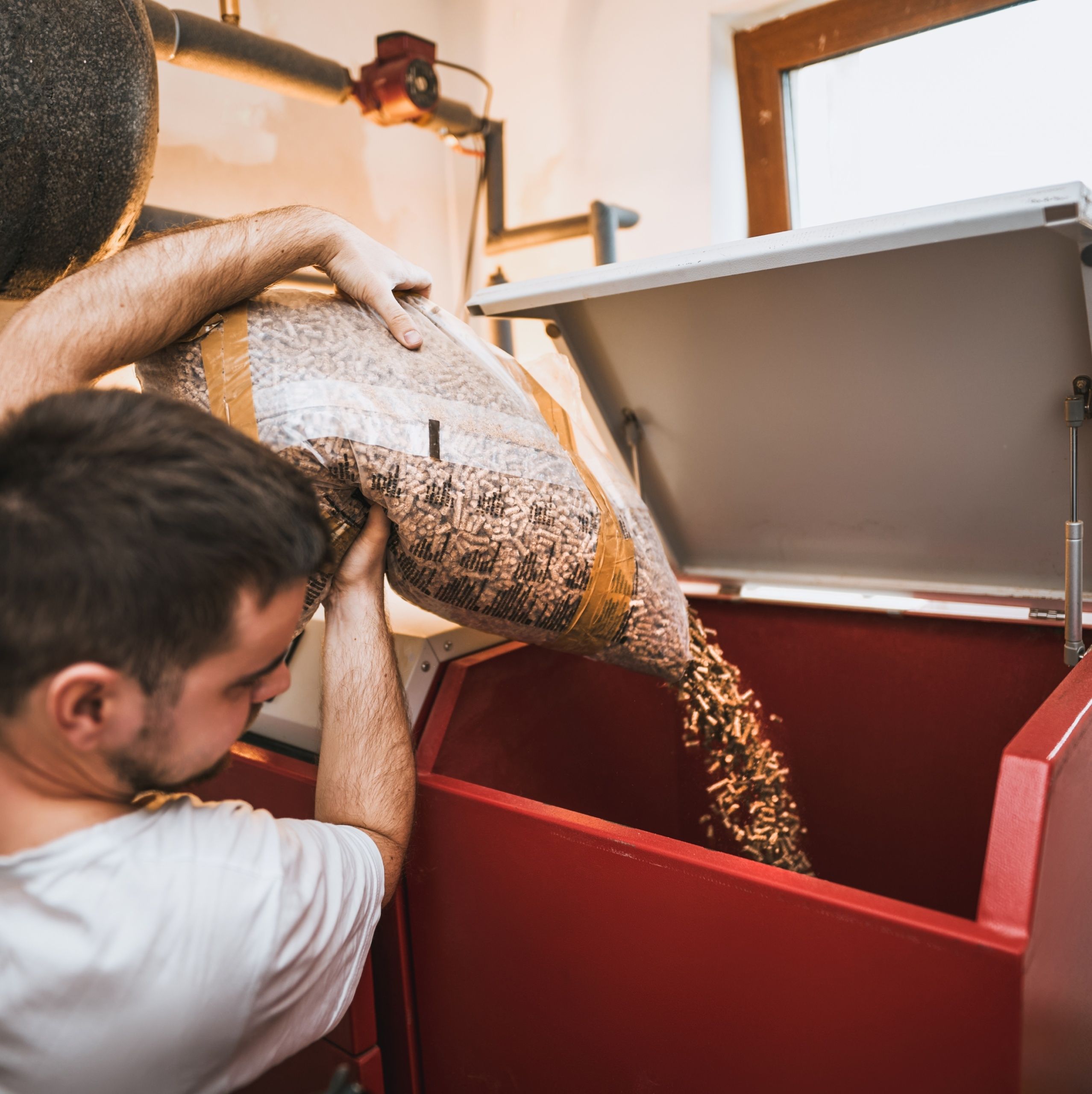 Man,Loading,Up,Pellet,Heating,Stove.,Worker,In,A,Boiler