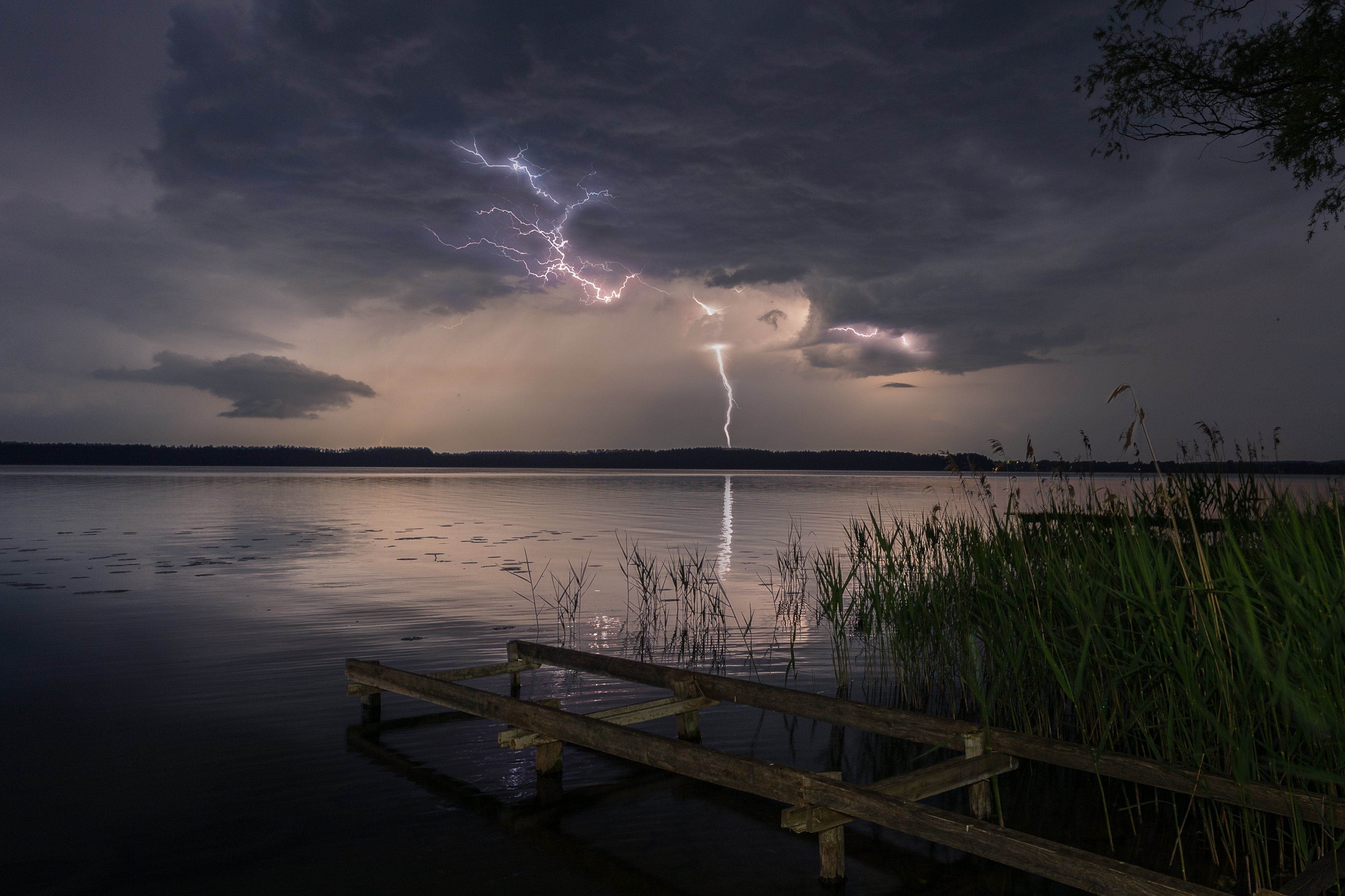 Multiple,Lightning,Bolts,Strike,Over,A,Calm,Lake,During,A