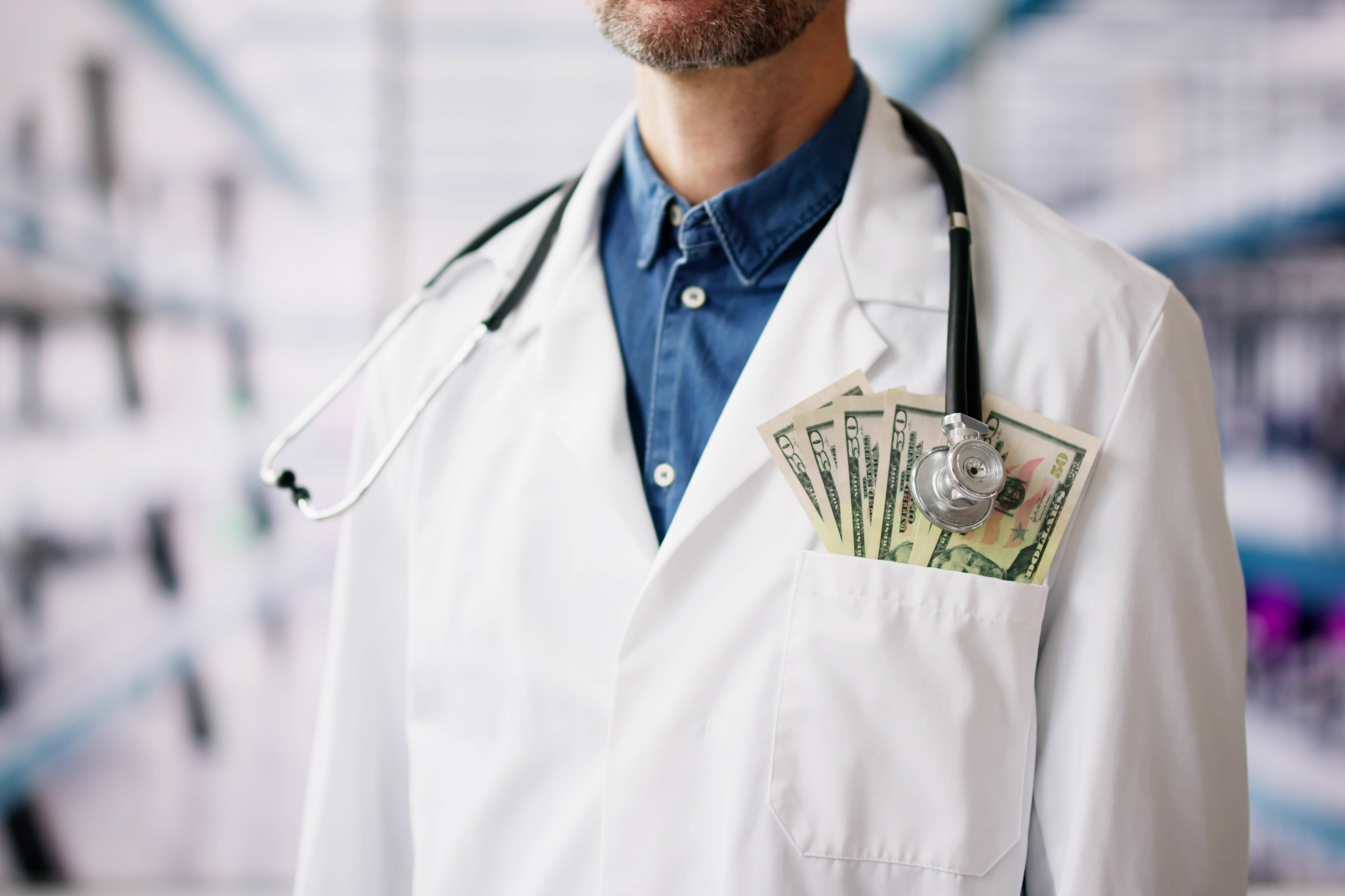 Rich,Doctor,Holding,Money.,Good,Cash,In,Clinic