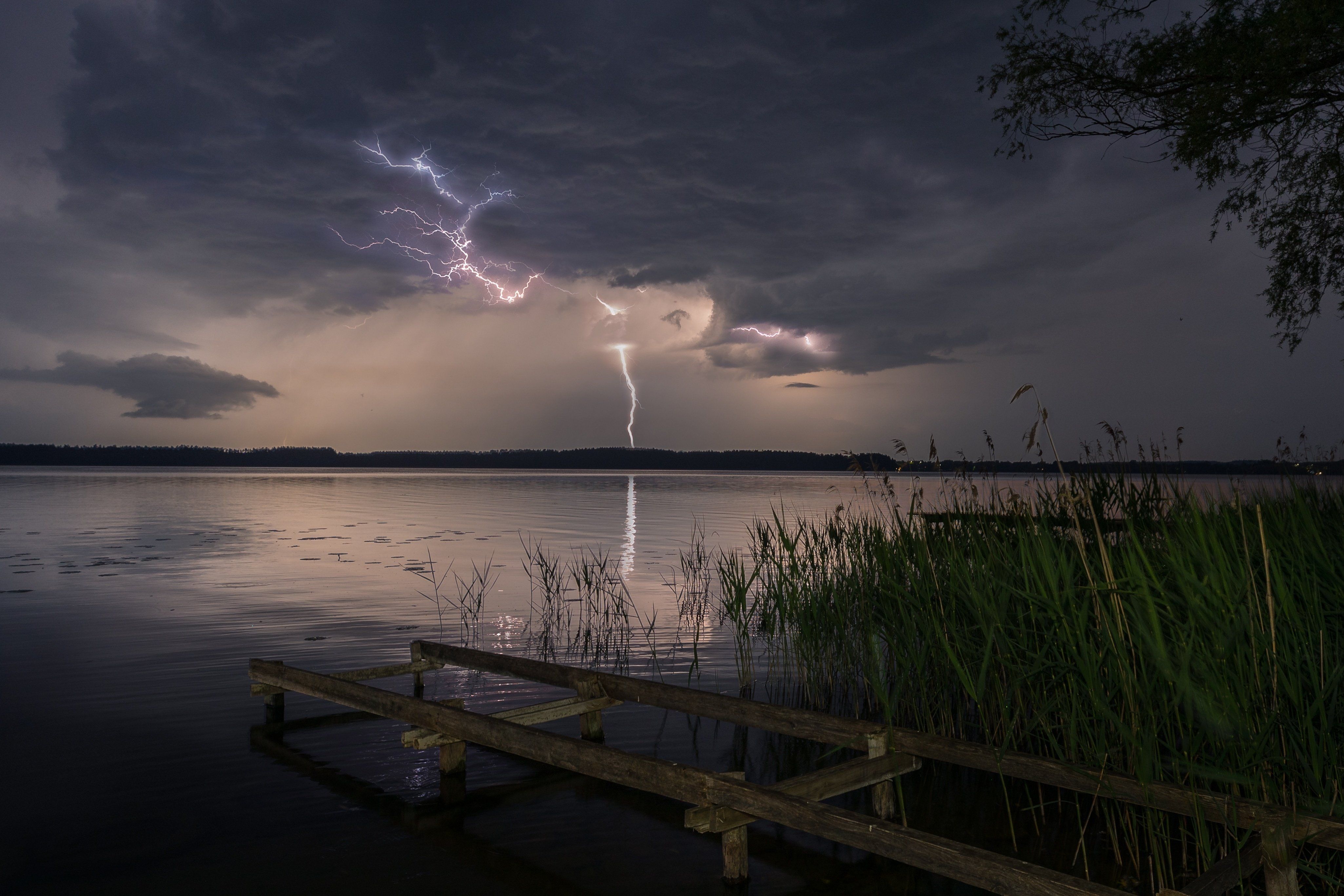 Multiple,Lightning,Bolts,Strike,Over,A,Calm,Lake,During,A