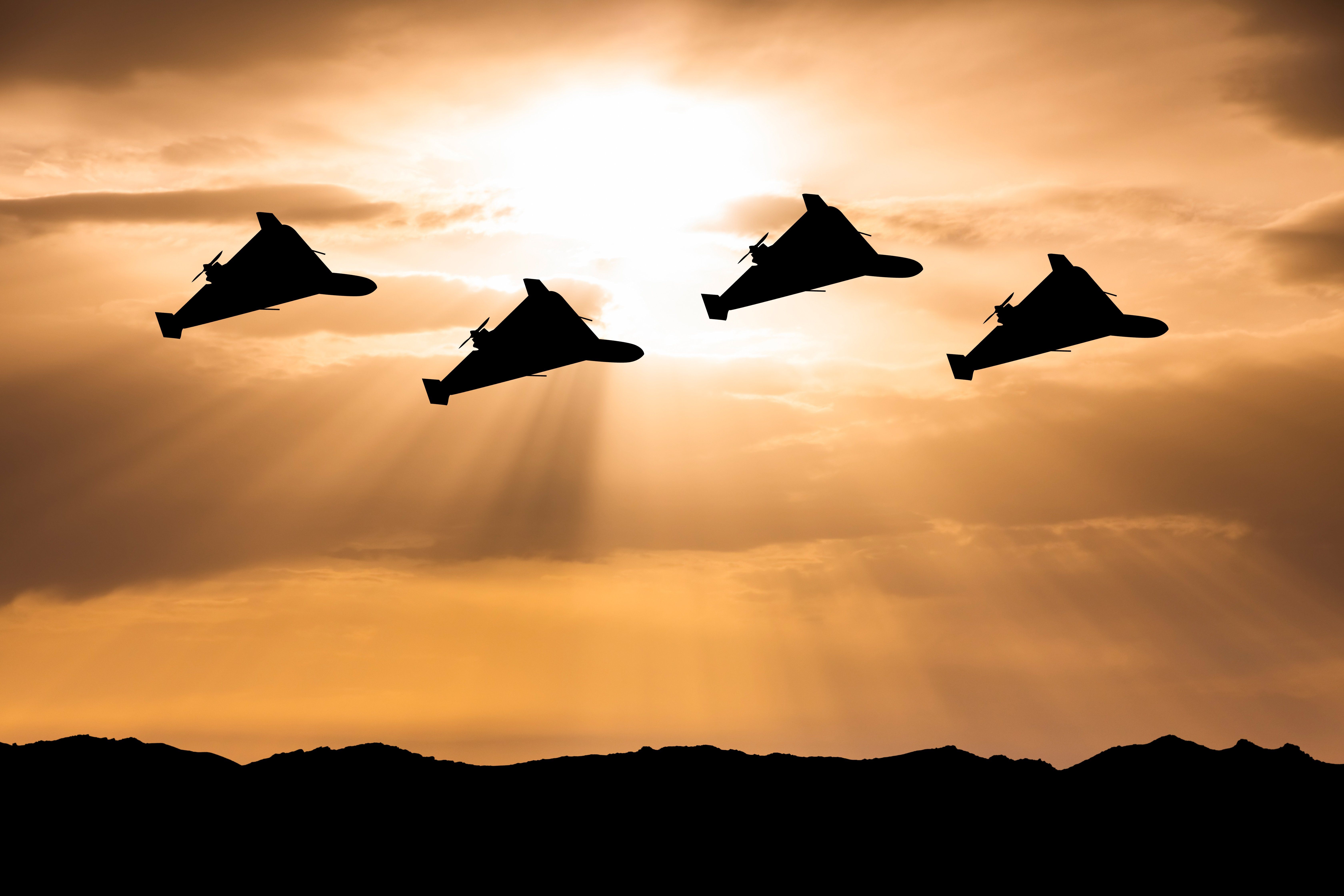 Heavy kamikaze drones at sunset sky. Drone attack