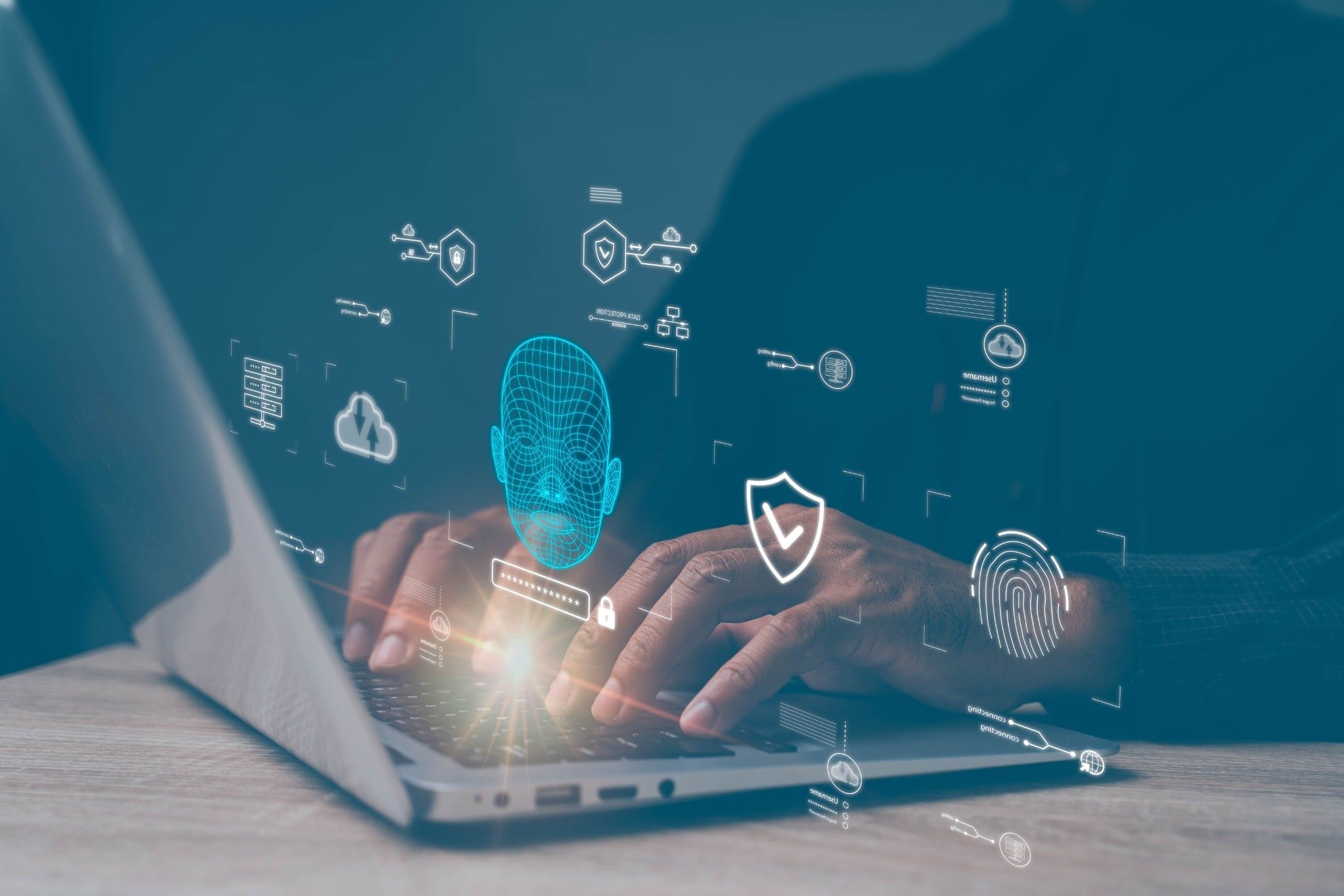 Dłonie na klawiaturze laptopa z cyfrową grafiką symbolizującą zabezpieczenia danych i sztuczną inteligencję, w tym podświetloną siatkową twarz 3D obrazującą rozpoznawanie twarzy