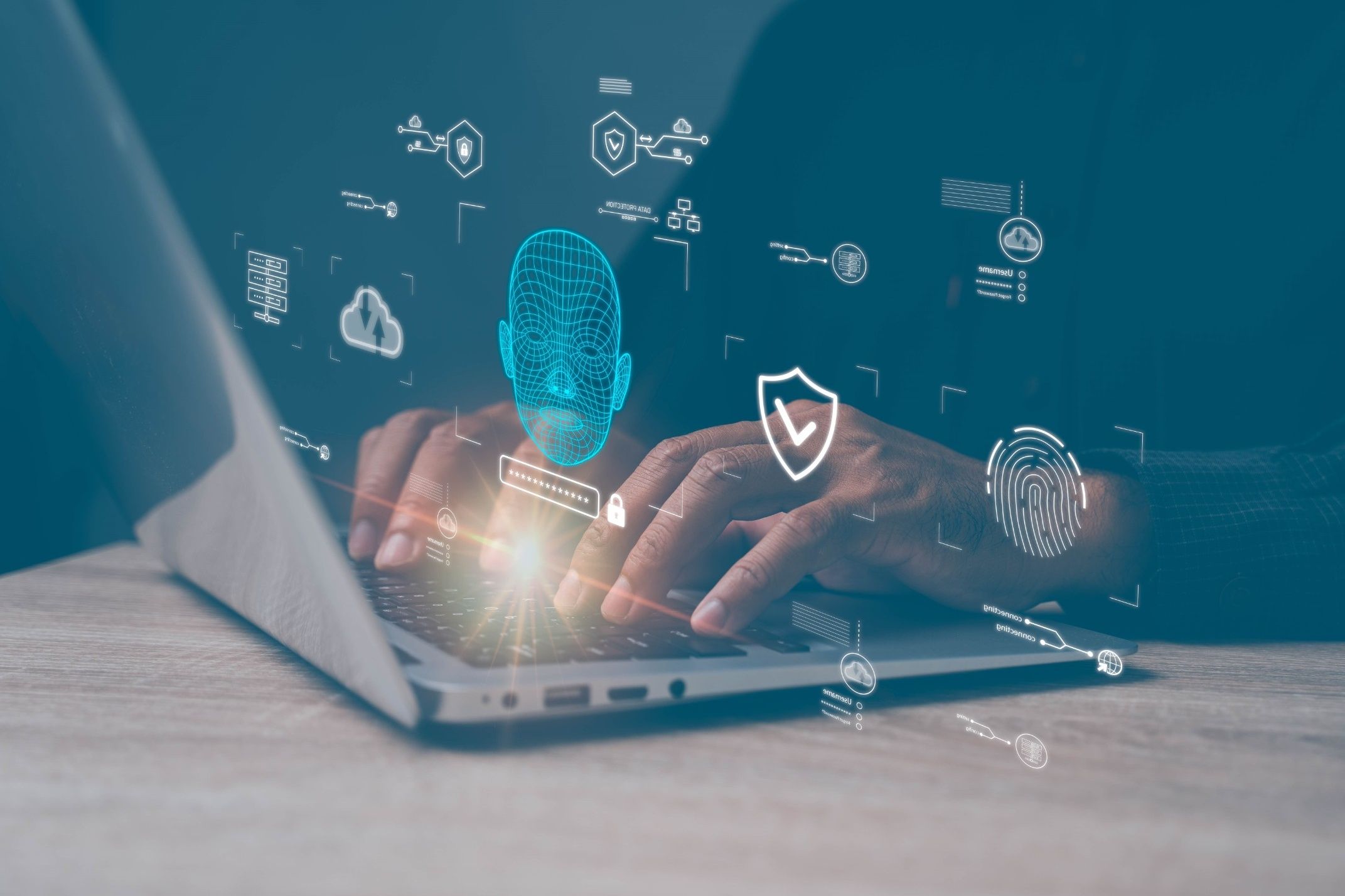 Dłonie na klawiaturze laptopa z cyfrową grafiką symbolizującą zabezpieczenia danych i sztuczną inteligencję, w tym podświetloną siatkową twarz 3D obrazującą rozpoznawanie twarzy
