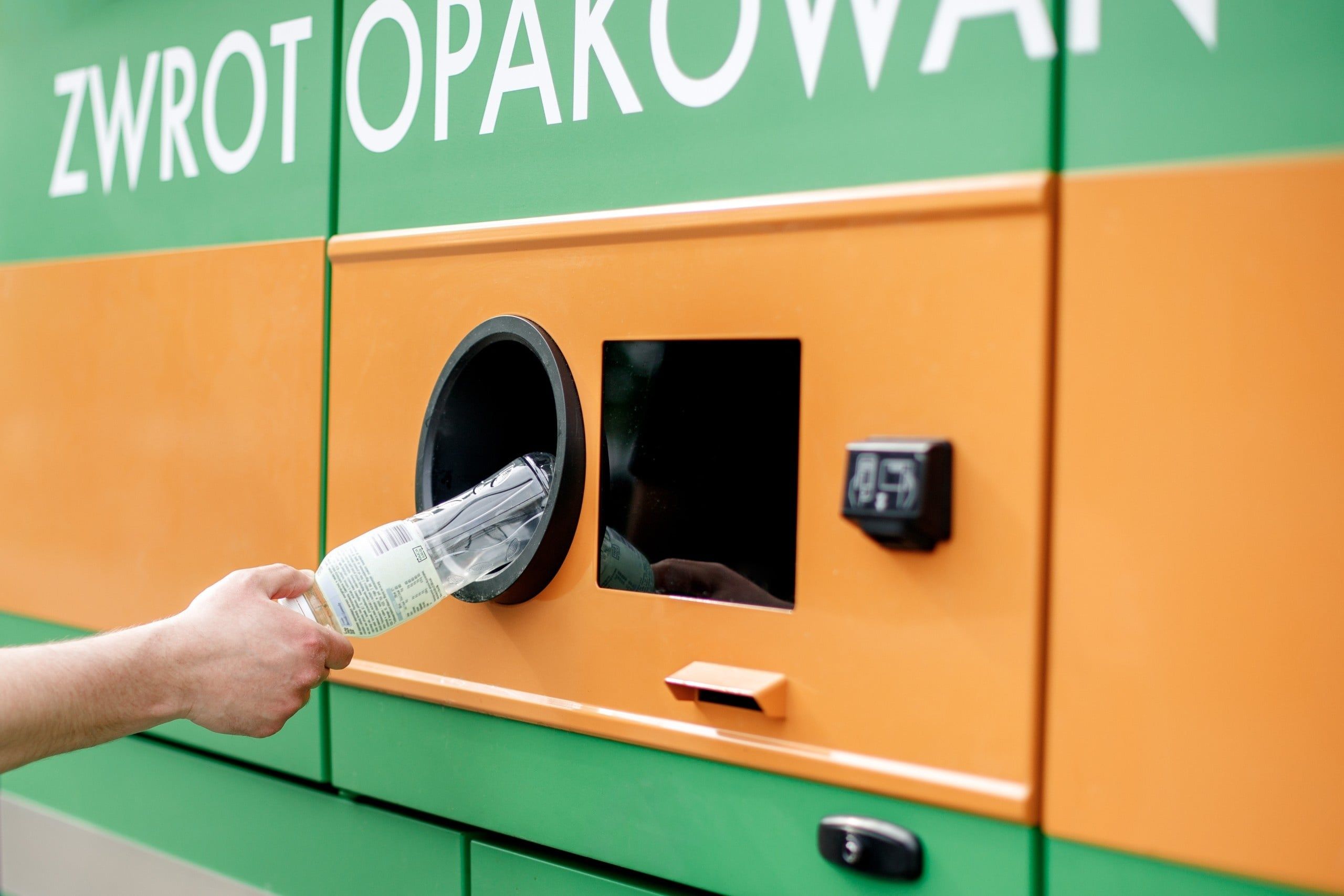 Man,Hand,Puts,Plastic,Bottle,To,The,Recycling,Machine.,Shoppers