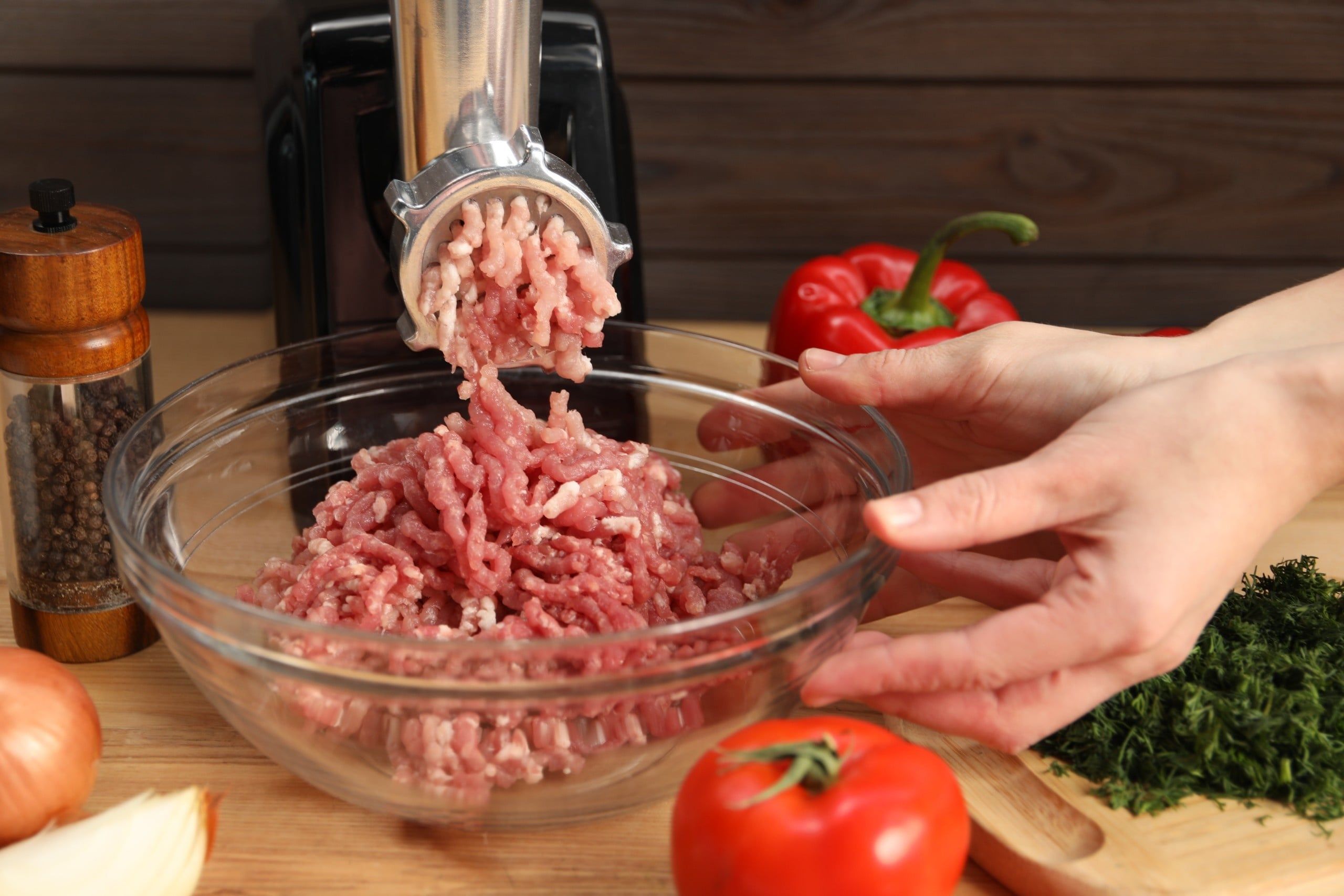 Woman,Making,Minced,Meat,With,Electric,Grinder,At,Wooden,Table