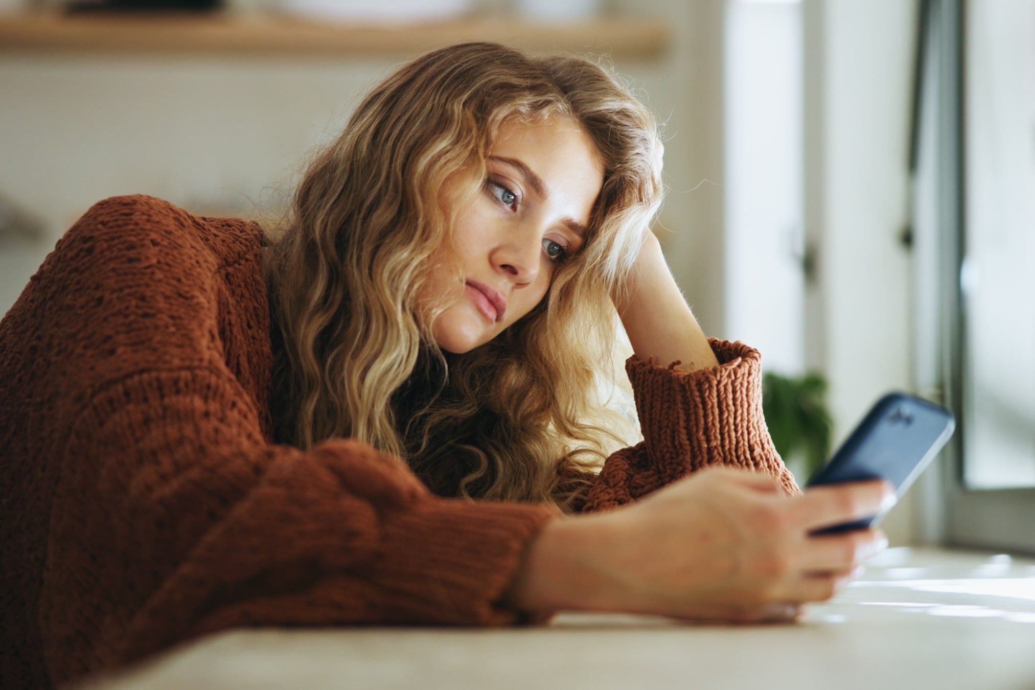 Woman,,Sad,And,Smartphone,In,Home,For,Reading,,Chat,And