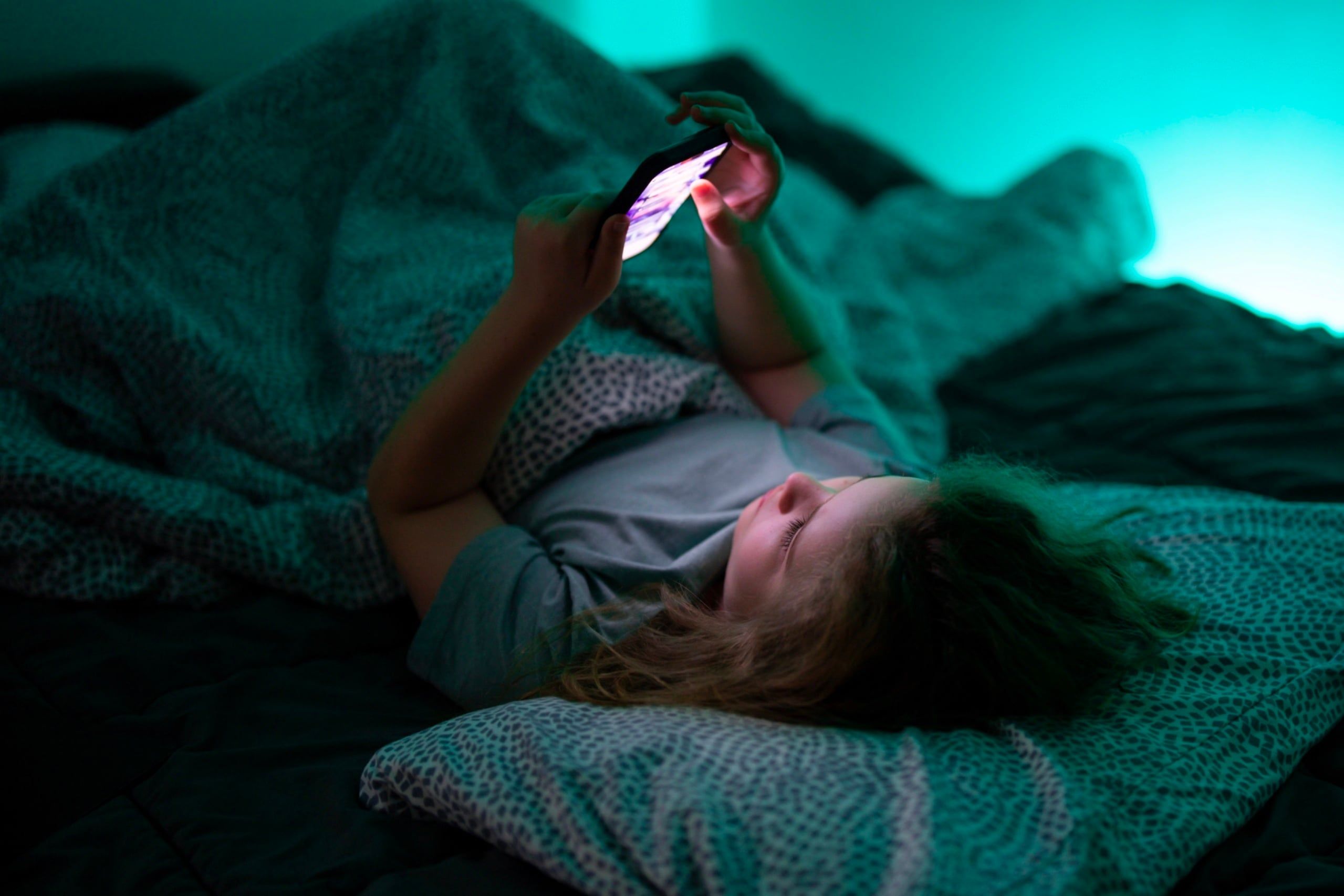 Child,Holding,Smartphone,Under,Blanket,Light.,Kid,Using,Technology,During