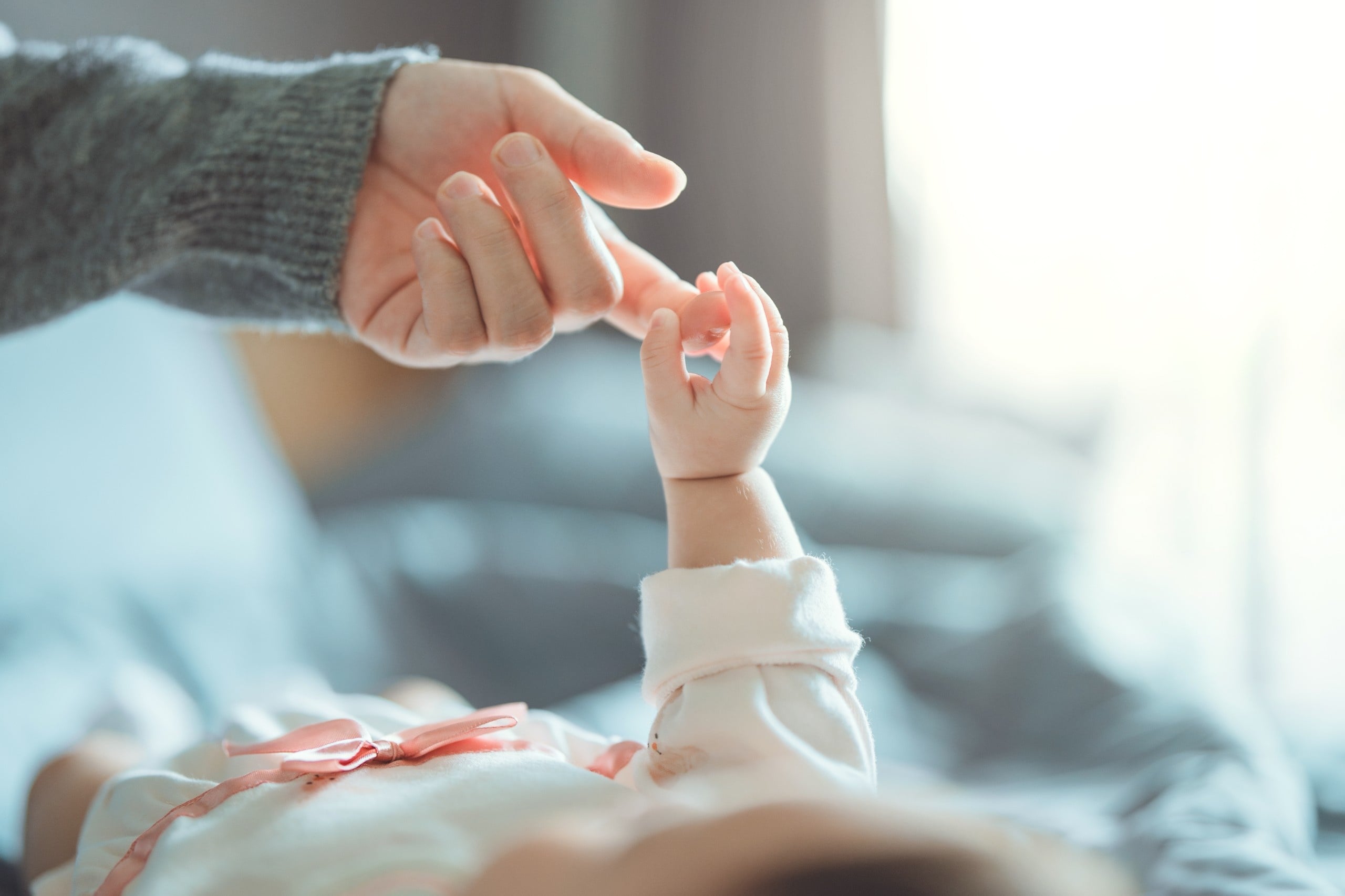 Newborn,Baby,Girl,Holding,Parent’s,Finger,–,Symbol,Of,Love,