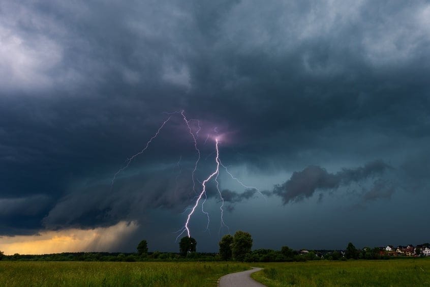 Lightning,Strike,Illuminating,Dramatic,Storm,Clouds,Over,Rural,Landscape,At