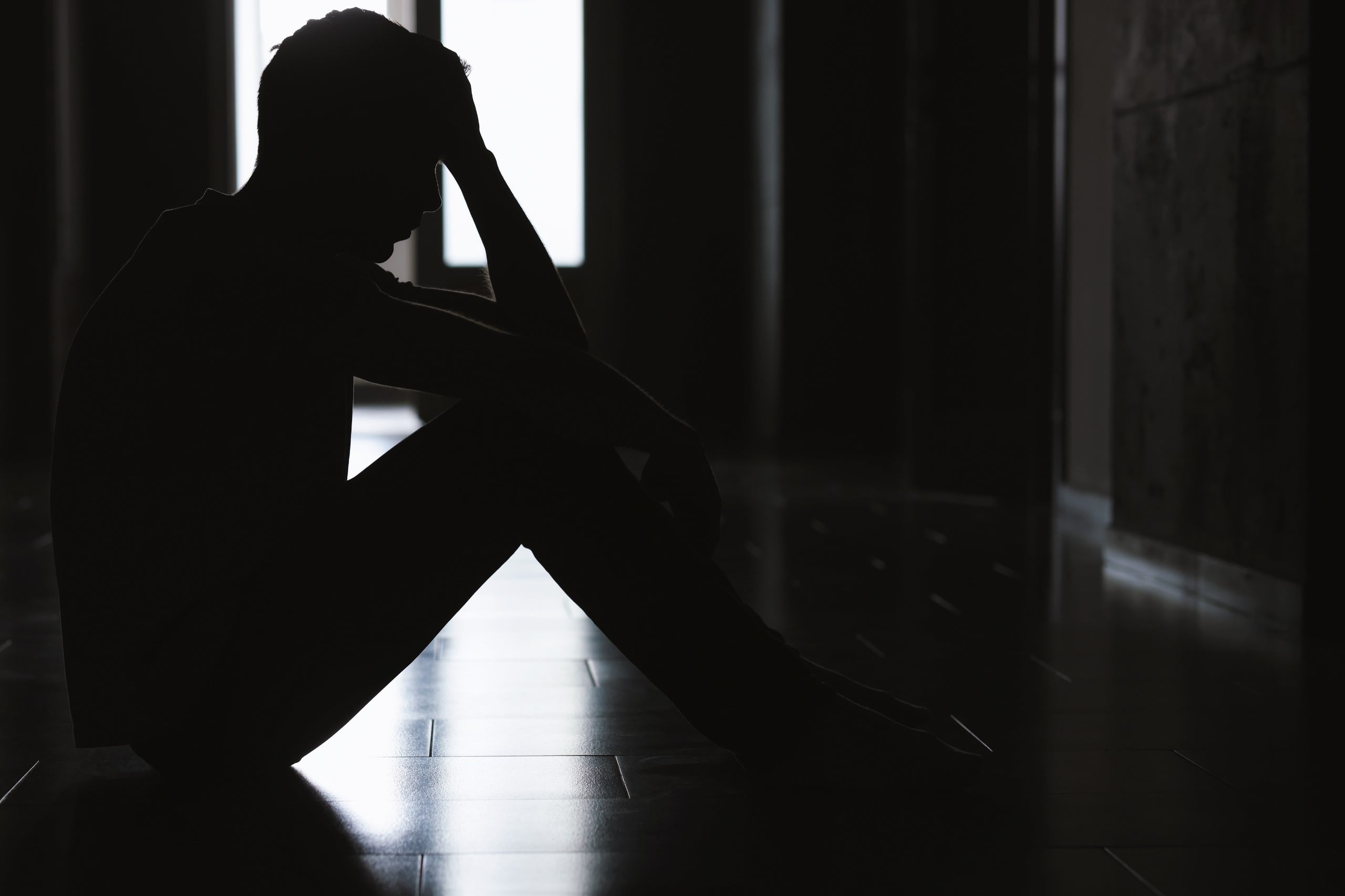 Sadness,And,Depression.,Silhouette,Of,Man,Sitting,On,Floor,In