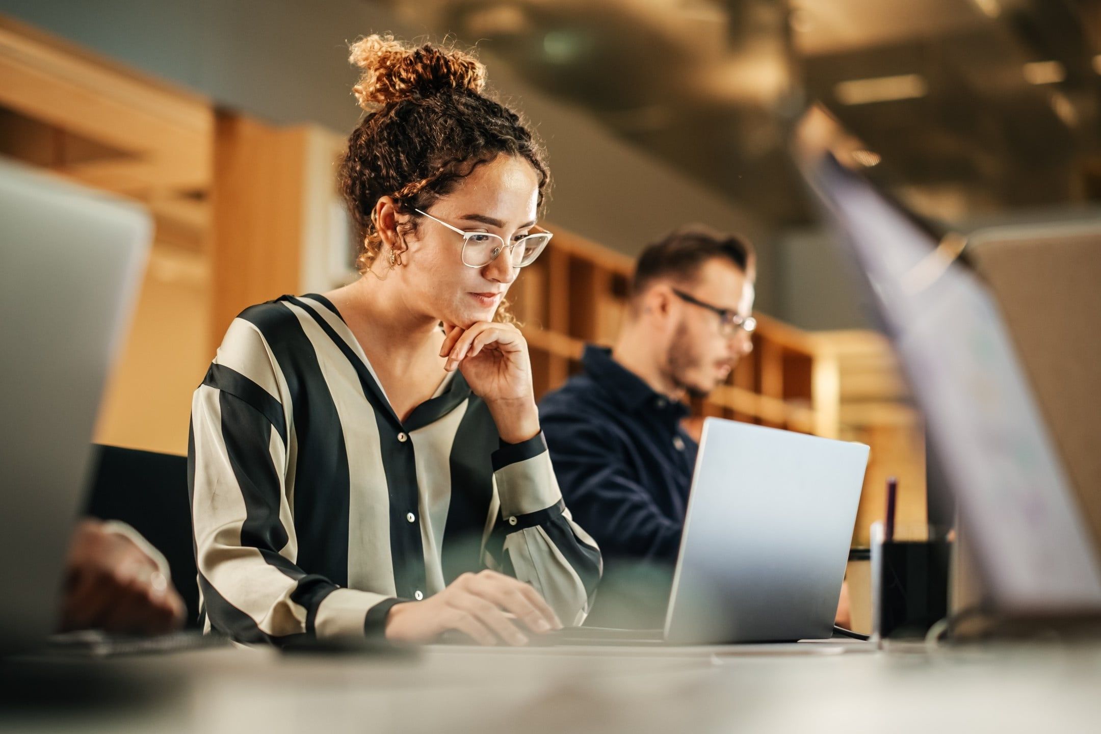 Portrait,Of,Enthusiastic,Hispanic,Young,Woman,Working,On,Computer,In