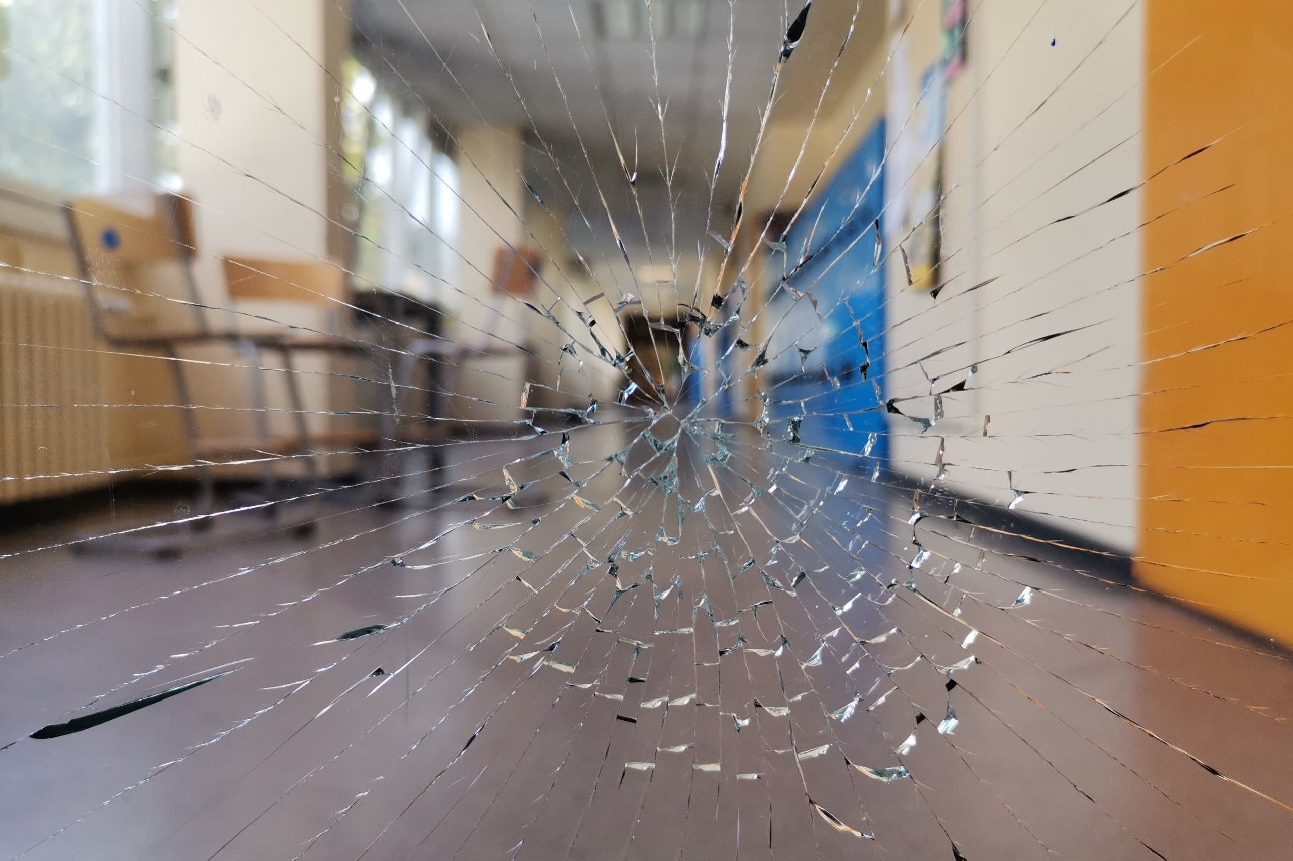 Cracked,Broken,Glass,Window,In,A,School,Corridor.,School,Violence.