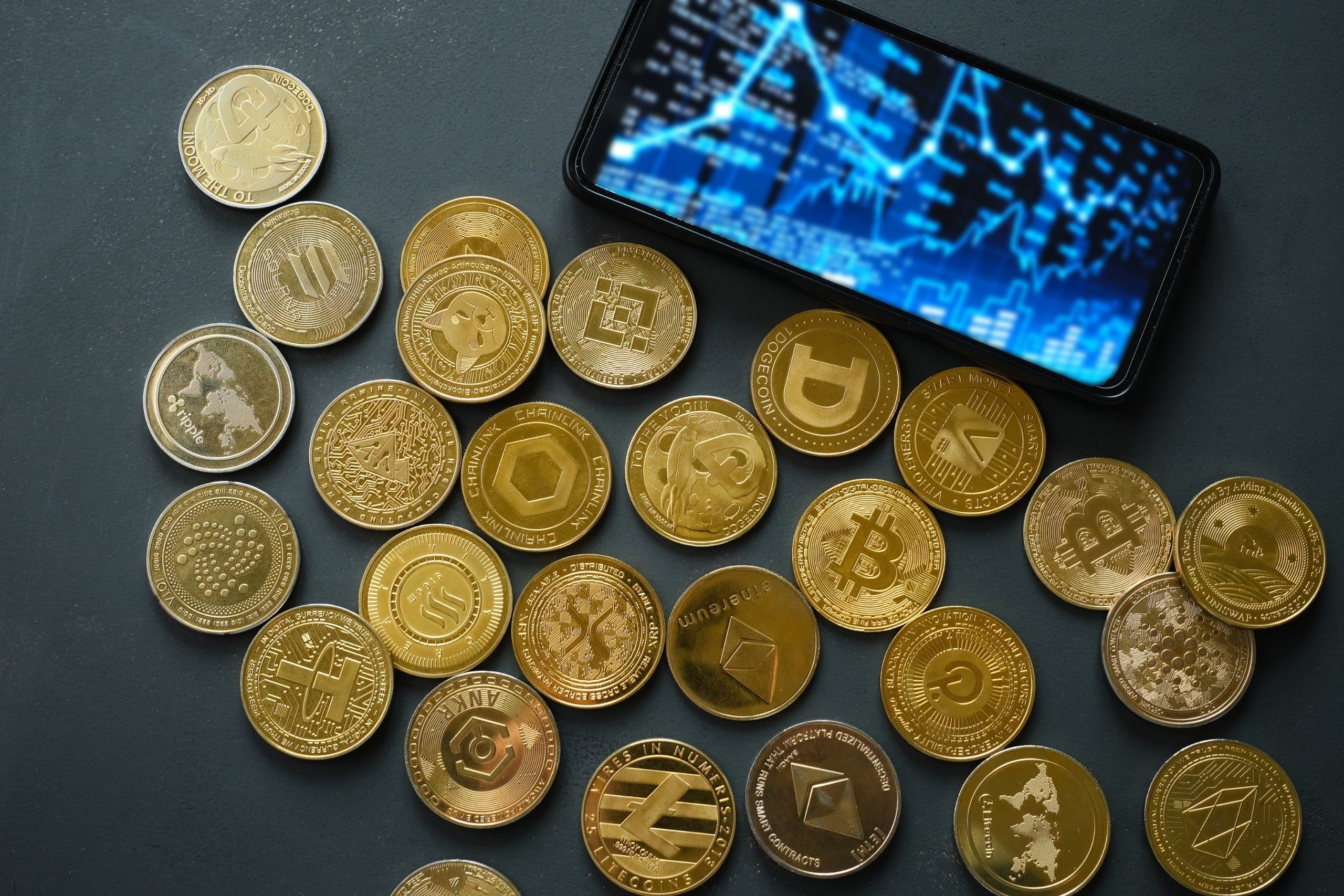 Various,Cryptocurrency,Coins,Lay,Scattered,On,A,Dark,Table.,A