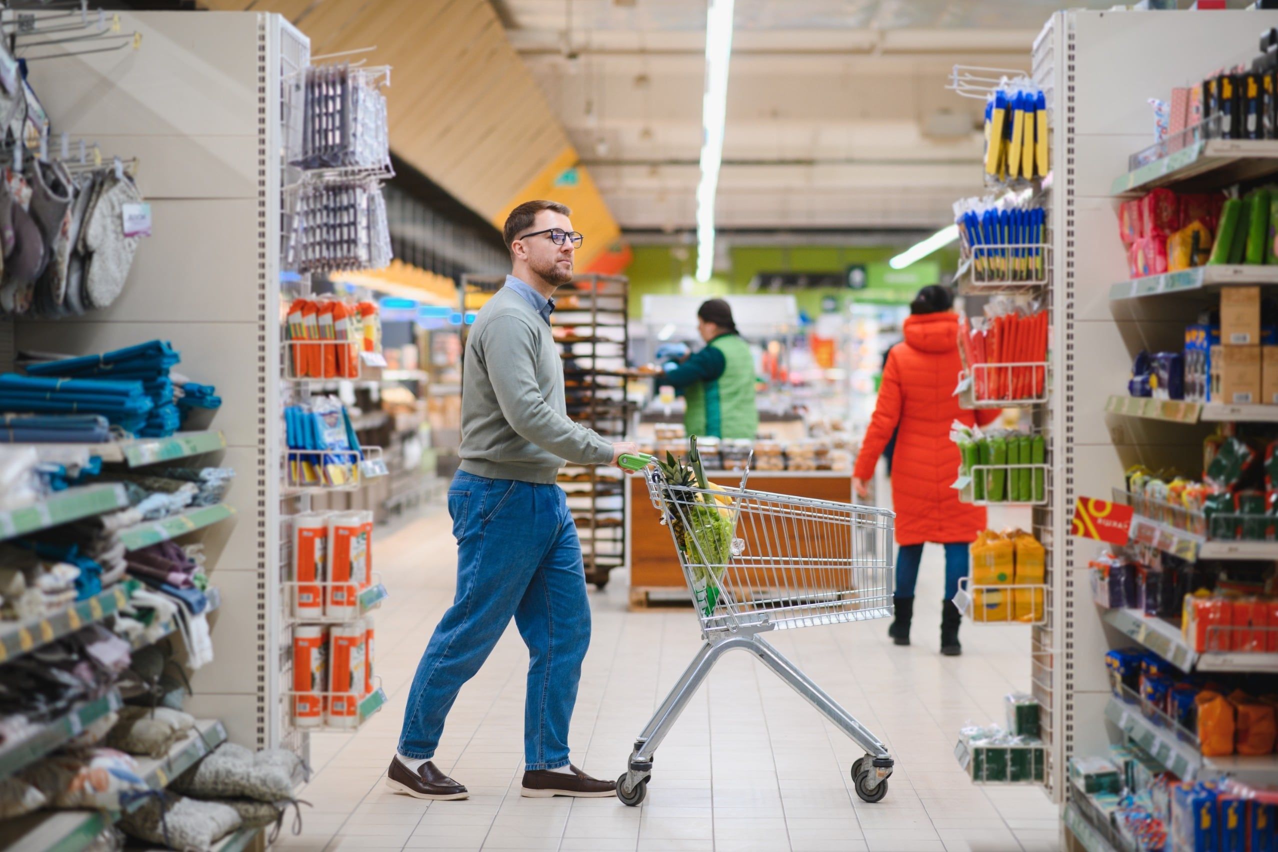 Young,Man,Buying,Groceries,At,The,Supermarket.,Consumerism,Concept.