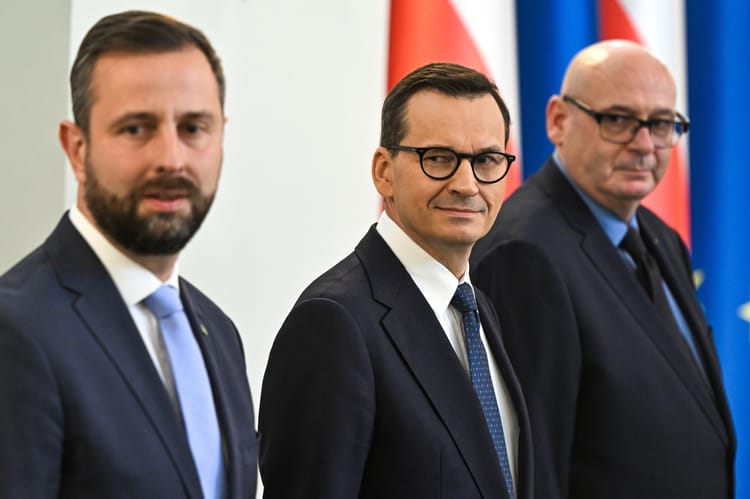 Władysław Kosiniak-Kamysz, Mateusz Morawiecki i Piotr Zgorzelski na tle flag Polski i Unii Europejskiej