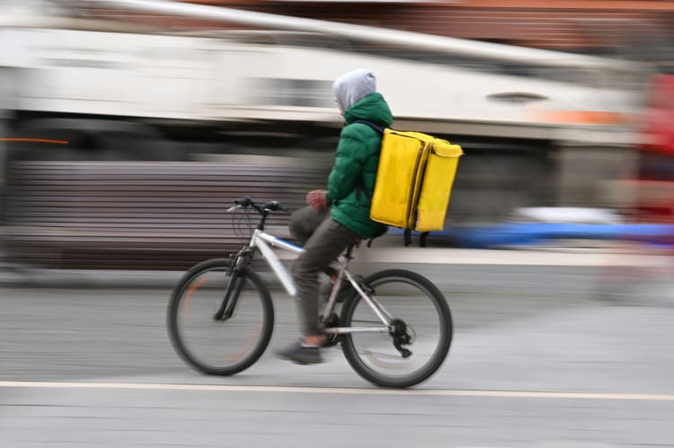 Blurred,Image,Of,A,Food,Delivery,Courier,Delivering,Food.,Motion