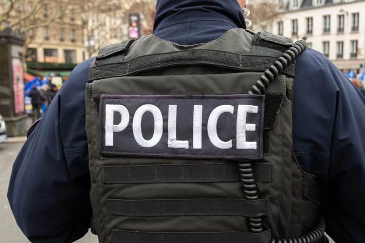 "police",Sign,Written,On,The,Back,Of,A,French,Police