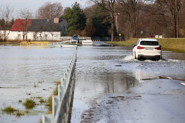 02.14.2024,Wroclaw,,Poland,,A,Car,Drives,Down,A,Flooded,Road.