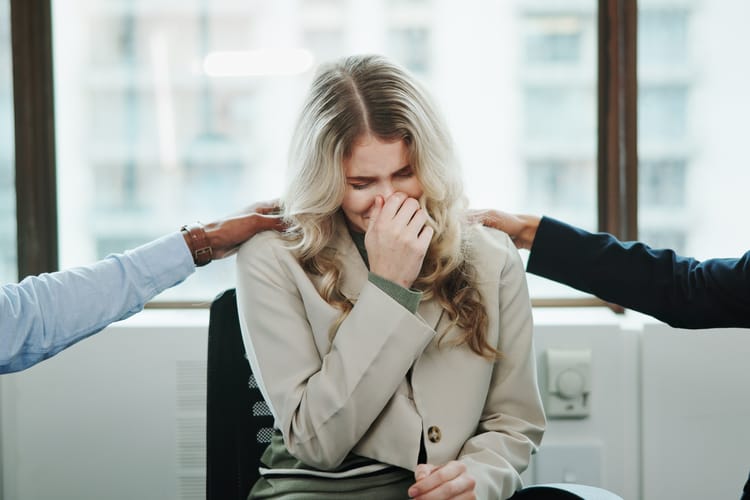 Sad,Woman,,Meeting,And,Support,Group,With,Team,At,Office