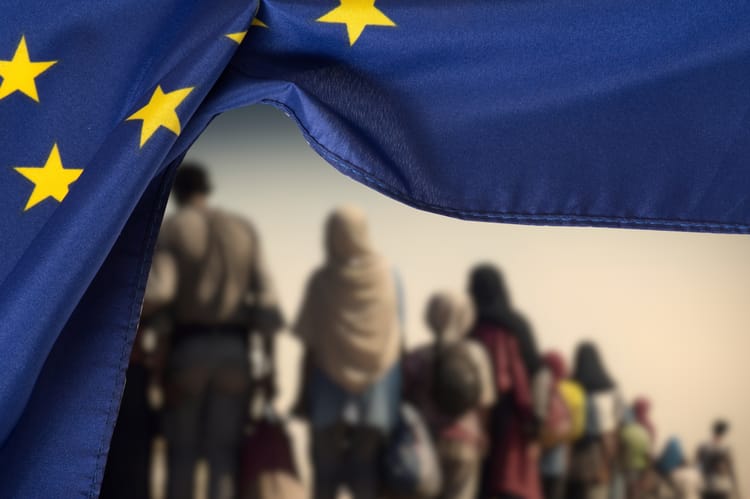 Flaga Unii Europejskiej UE i grupa migrantów.