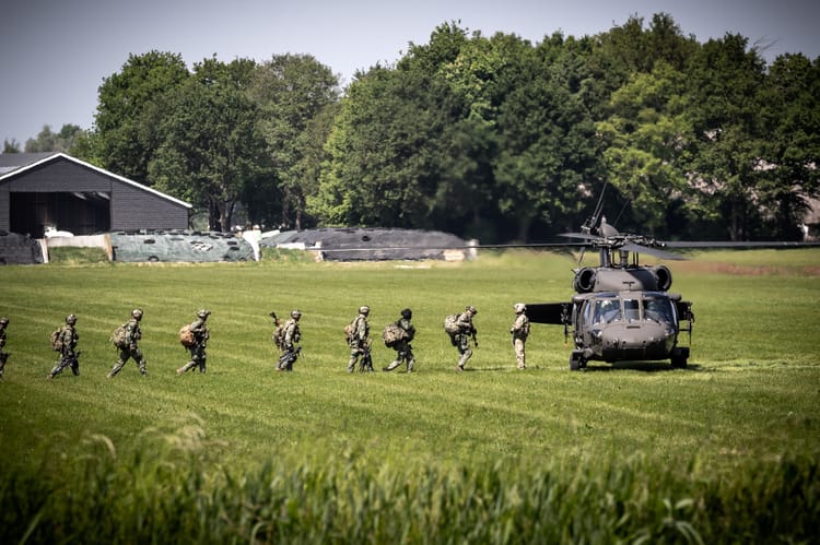 Nato,Troops,Walking,To,A,Us,Army,Uh-60,Blackhawk,Helicopter